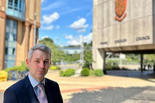 Will Forster stands outside the Woking Borough Council offices