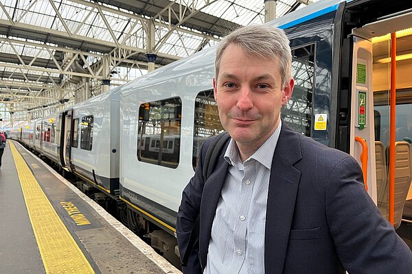 Will standing by a train at Waterloo